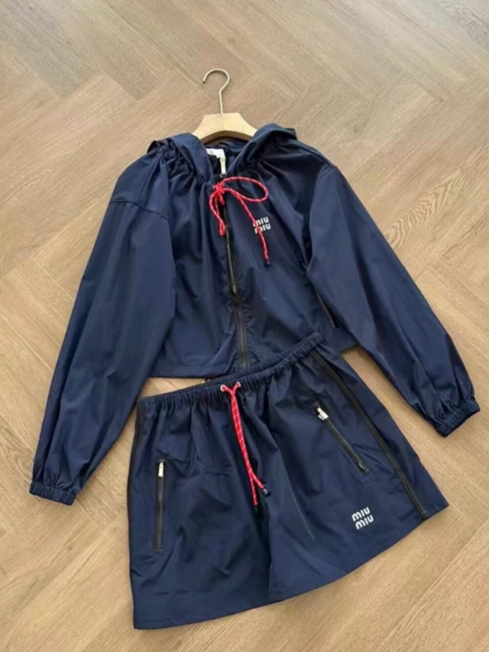 This Miu Miu trench coat features exquisite